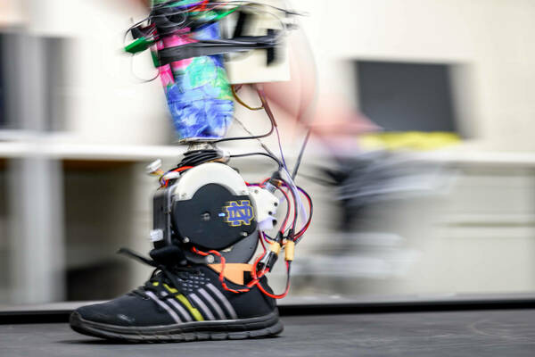 A slightly blurred moving powered prosthetic ankle mimics the movement of a real foot.